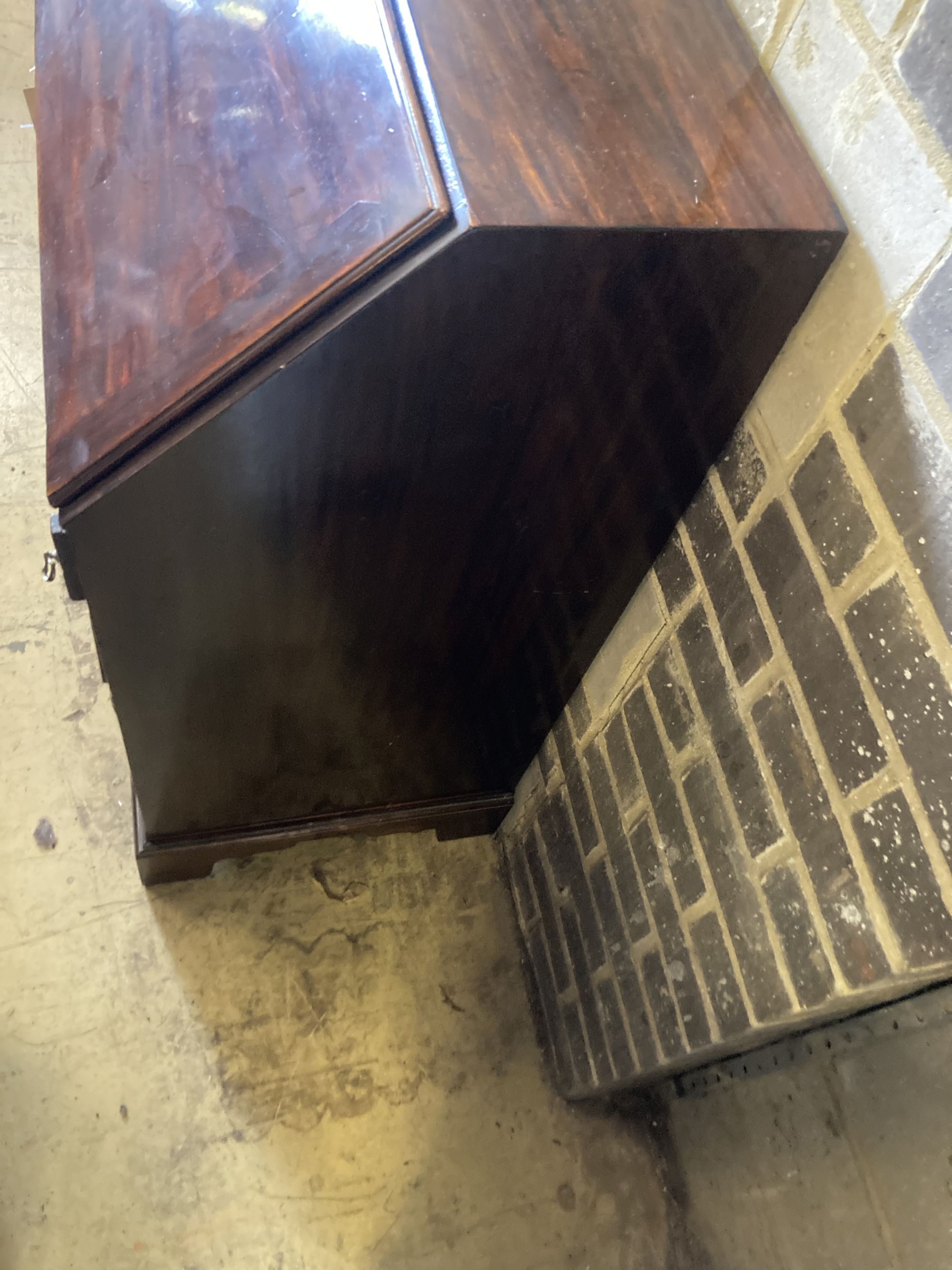 A George III mahogany bureau, the fall enclosing drawers, pigeon holes and secret compartments over four long drawers, width 97cm, dept